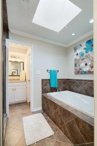 a bedroom with a bed and painting on the wall