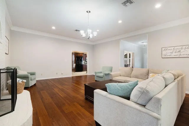 a living room with furniture and a chandelier
