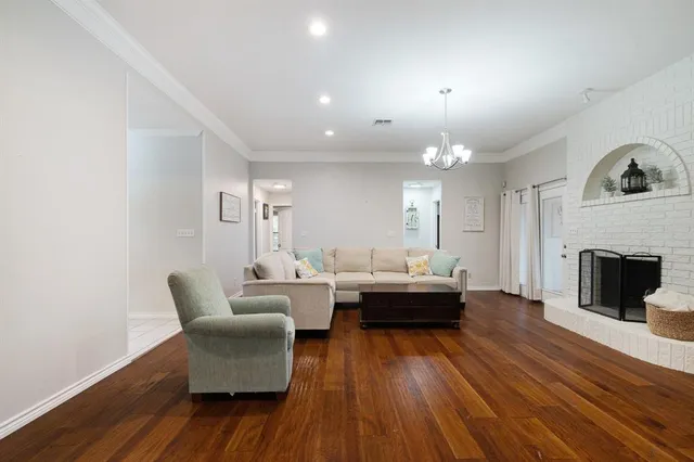 a living room with fireplace furniture and a wooden floor