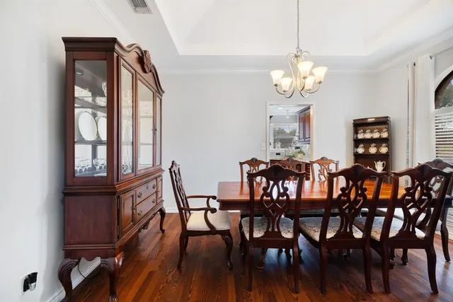 a view of a dining room with furniture wooden floor and chandelier