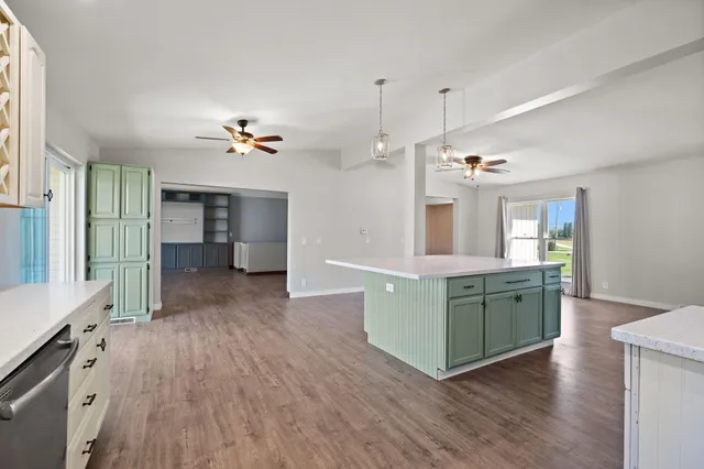 a view of kitchen and center island with wooden floor
