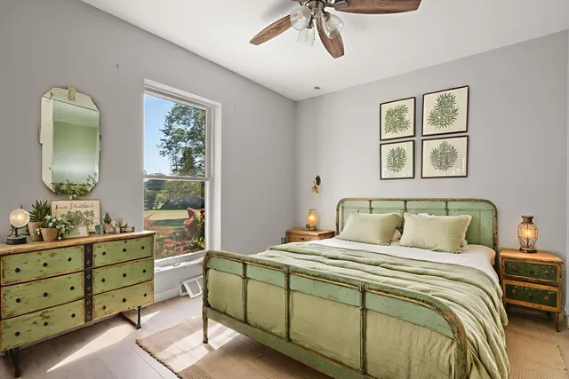 a bedroom with a bed and a dresser in it