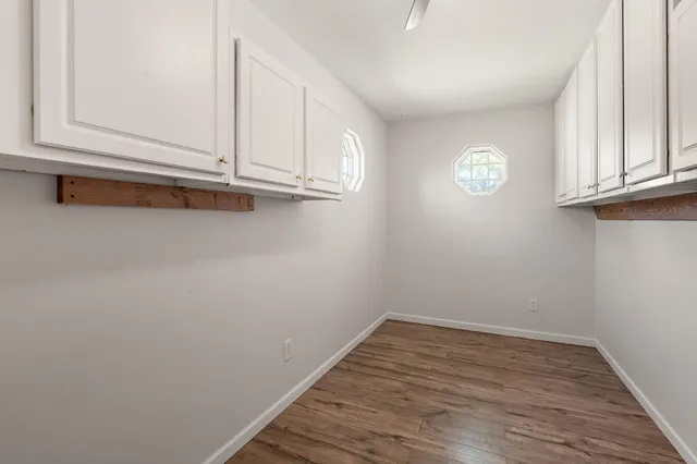 a view of empty room with wooden floor