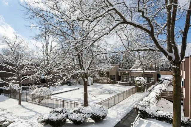 a utility room with stainless steel appliances washer and dryer