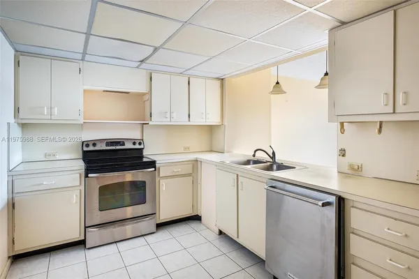 a kitchen with white cabinets and white appliances