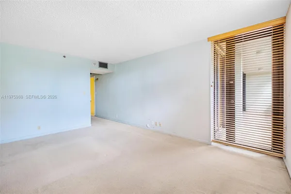 a view of an empty room with a window