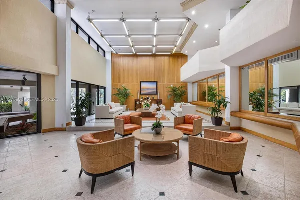 a living room with furniture a flat screen tv and a large window