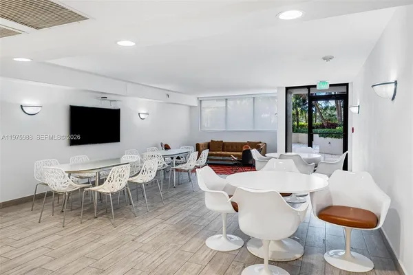 a kitchen with stainless steel appliances granite countertop a refrigerator a sink dishwasher and a stove with white countertops