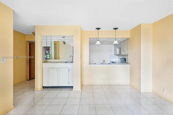 a kitchen with a sink stove top oven and cabinets