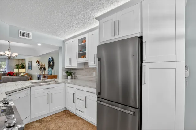 a white refrigerator freezer sitting inside of a kitchen