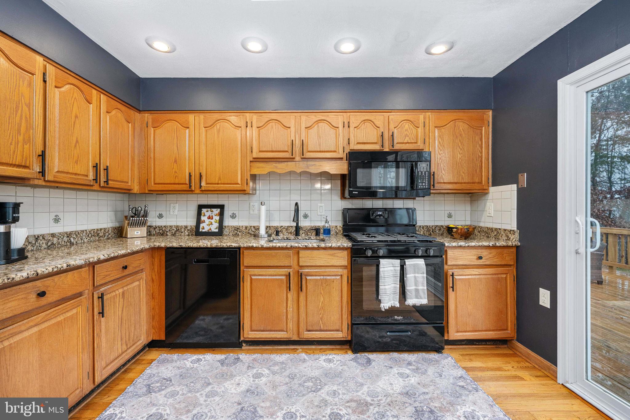 6765 Settlers Ridge Road Warrenton, VA 20187 - Photo 17 of 66 a kitchen with stainless steel appliances granite countertop a stove sink and cabinets