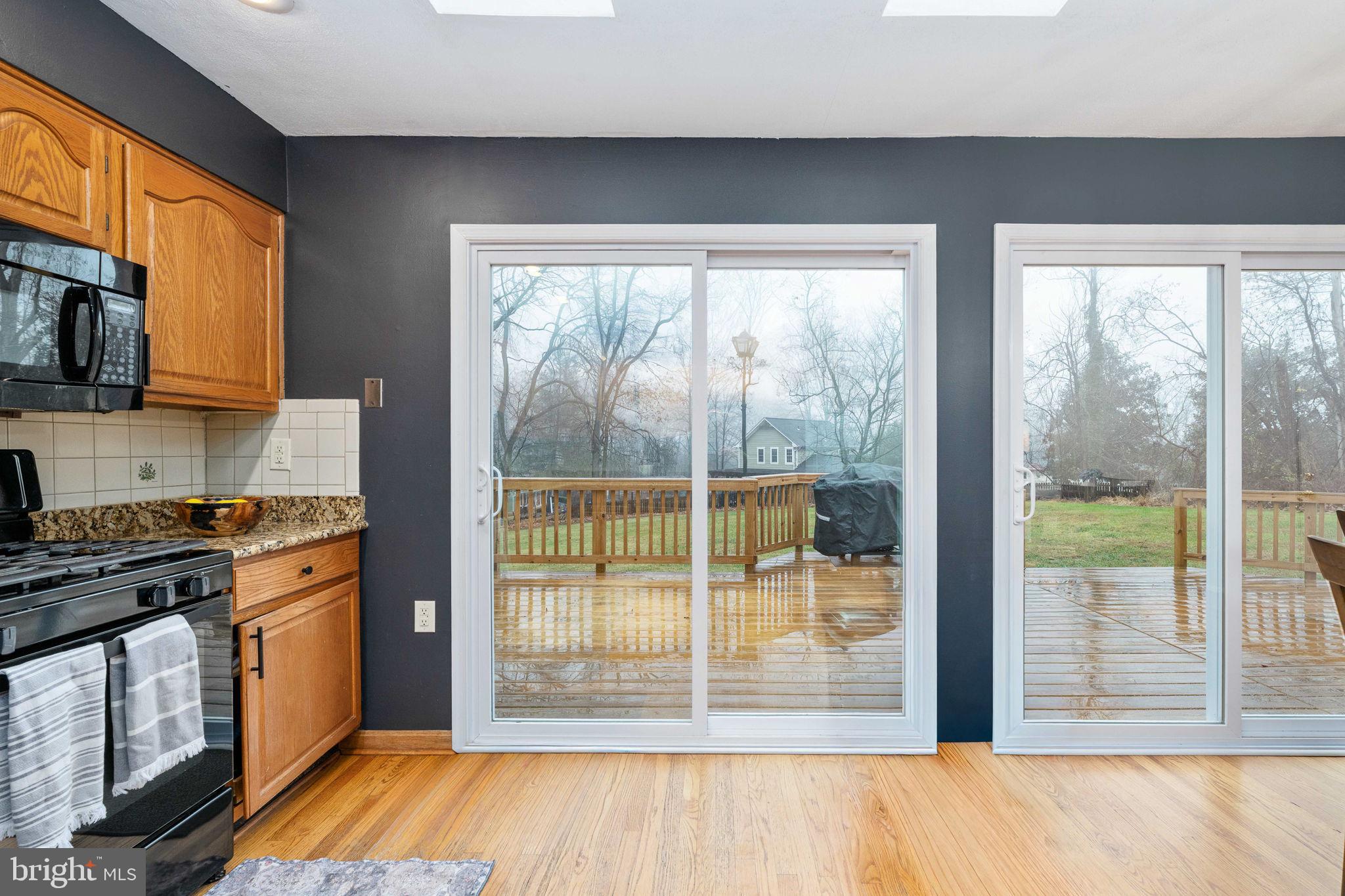 6765 Settlers Ridge Road Warrenton, VA 20187 - Photo 19 of 66 a kitchen with stainless steel appliances wooden cabinets and a stove top oven