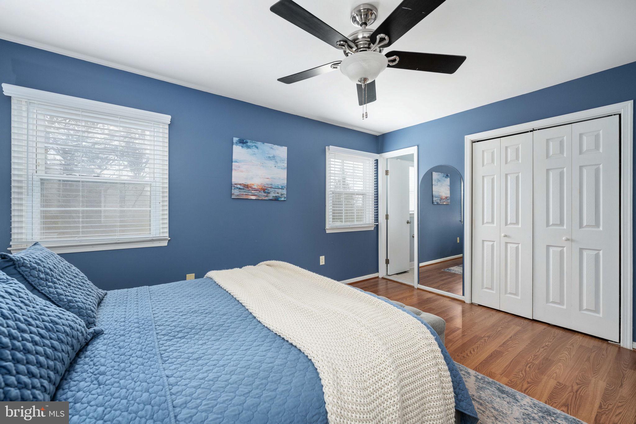 6765 Settlers Ridge Road Warrenton, VA 20187 - Photo 29 of 66 a bedroom with a large bed and a chandelier