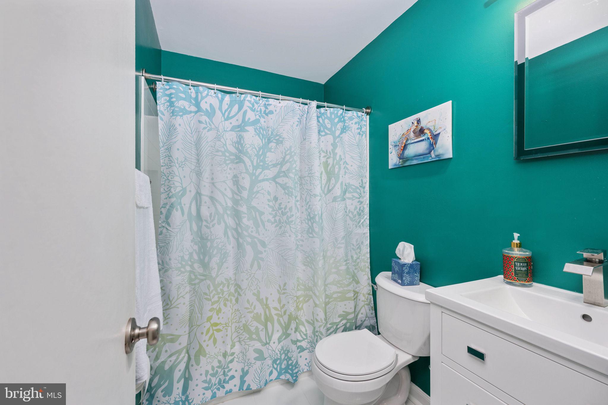 6765 Settlers Ridge Road Warrenton, VA 20187 - Photo 33 of 66 a bathroom with a toilet sink and shower curtain