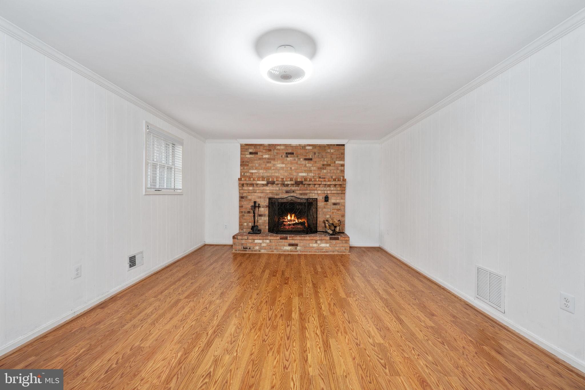 6765 Settlers Ridge Road Warrenton, VA 20187 - Photo 36 of 66 a view of an empty room with a fireplace and a window
