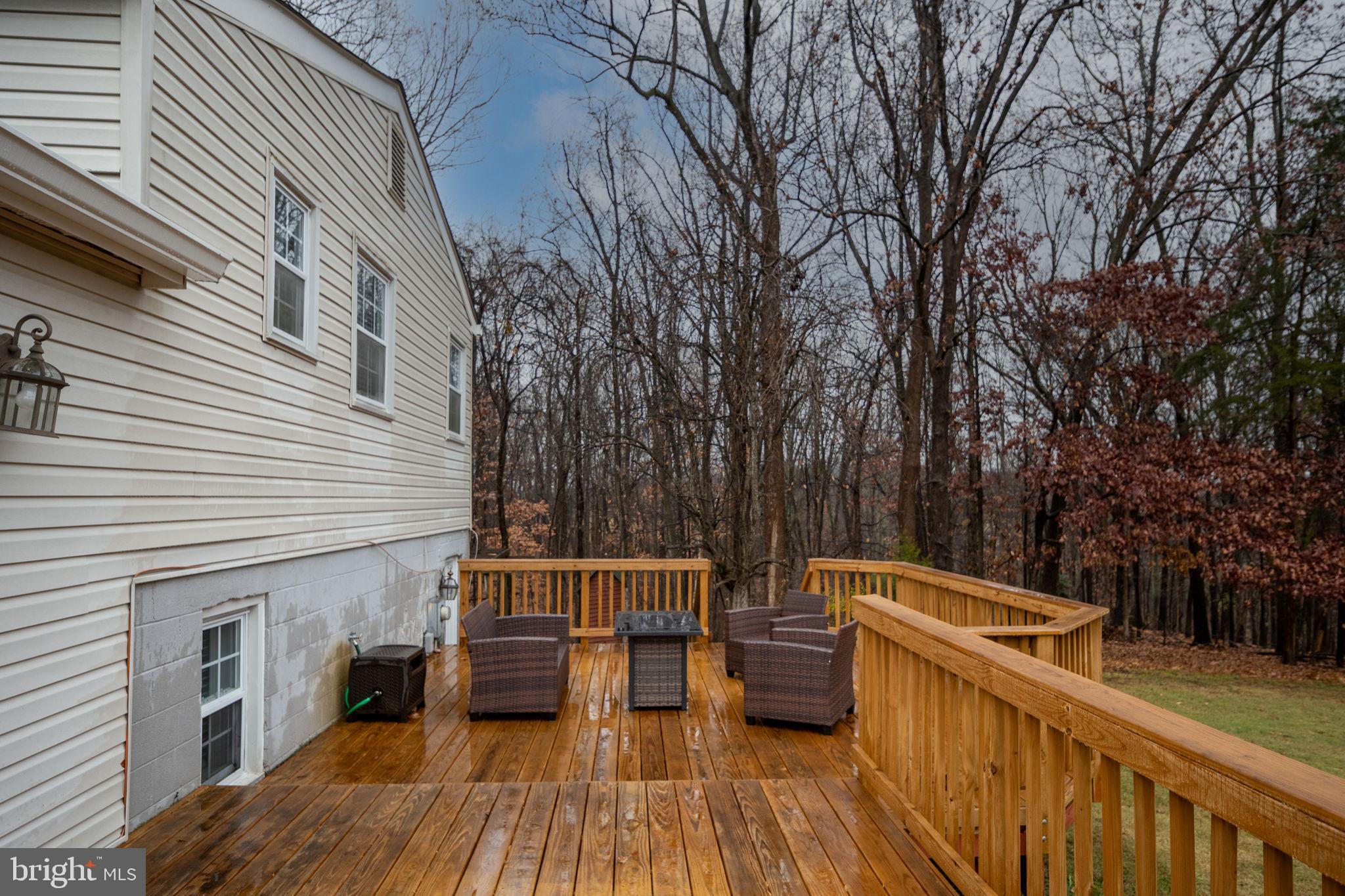 6765 Settlers Ridge Road Warrenton, VA 20187 - Photo 42 of 66 a view of a patio with table and chairs with wooden floor and fence
