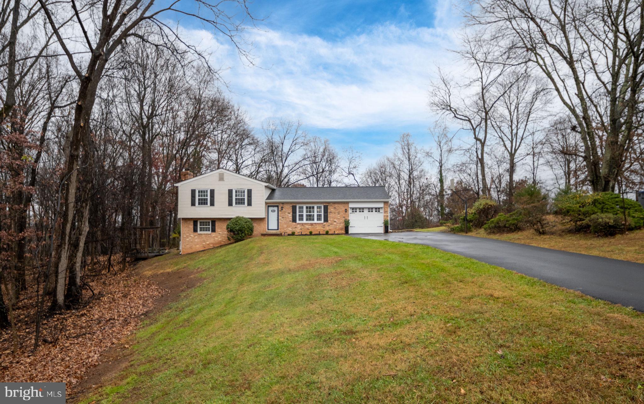6765 Settlers Ridge Road Warrenton, VA 20187 - Photo 6 of 66 a front view of a house with yard and green space