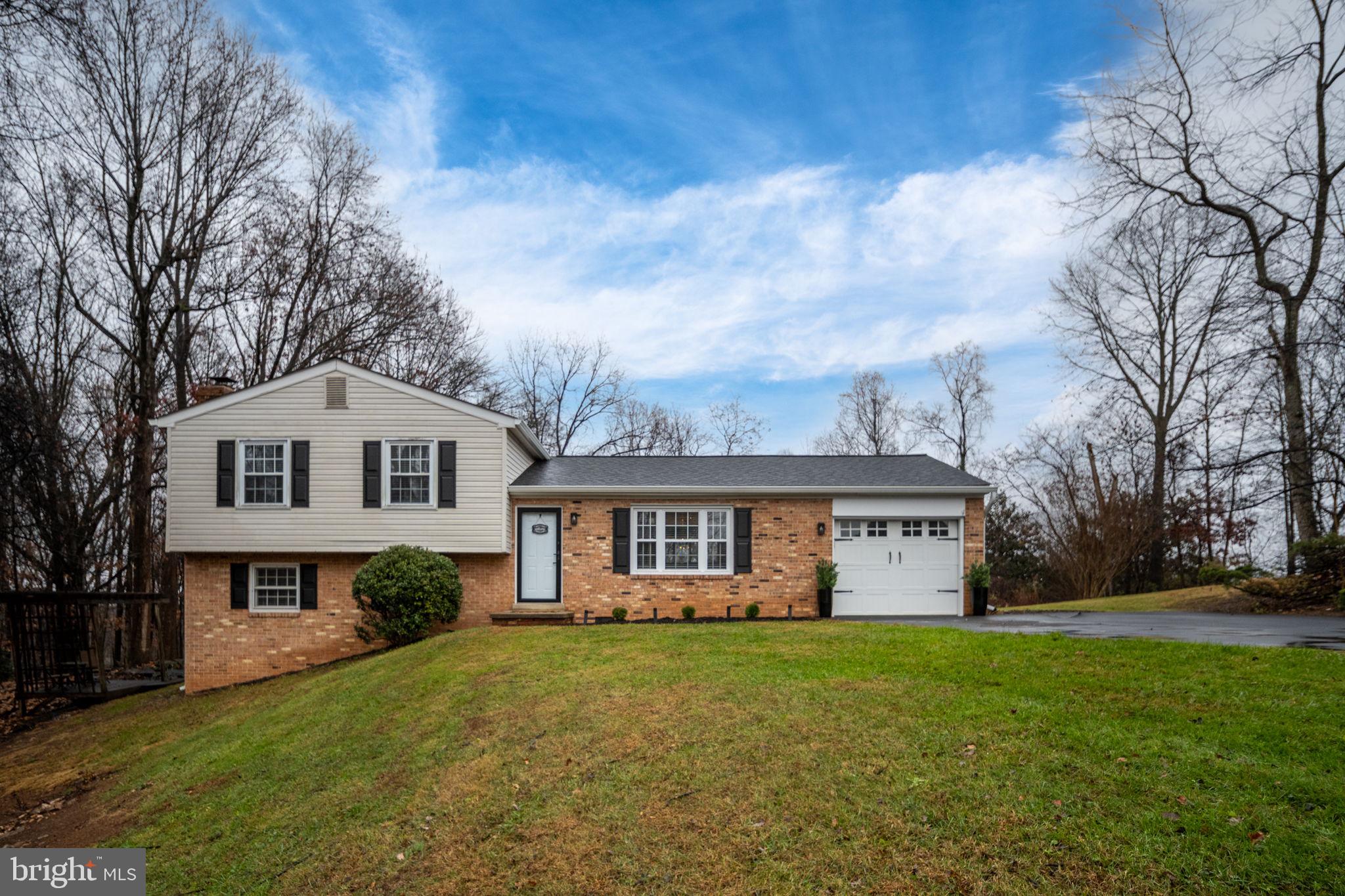 6765 Settlers Ridge Road Warrenton, VA 20187 - Photo 7 of 66 a front view of a house with a garden