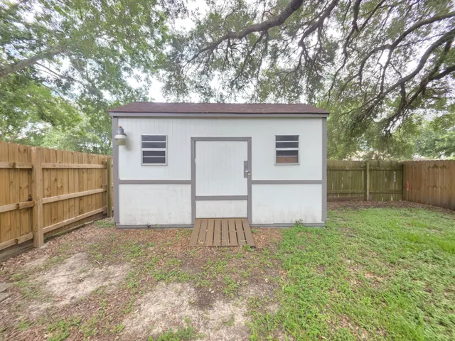 a view of backyard with small cabin