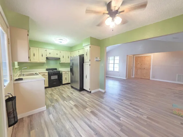 a large kitchen with cabinets and stainless steel appliances