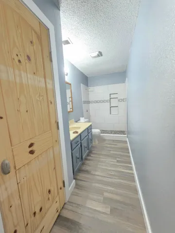 a view of a bathroom with sink and glass door