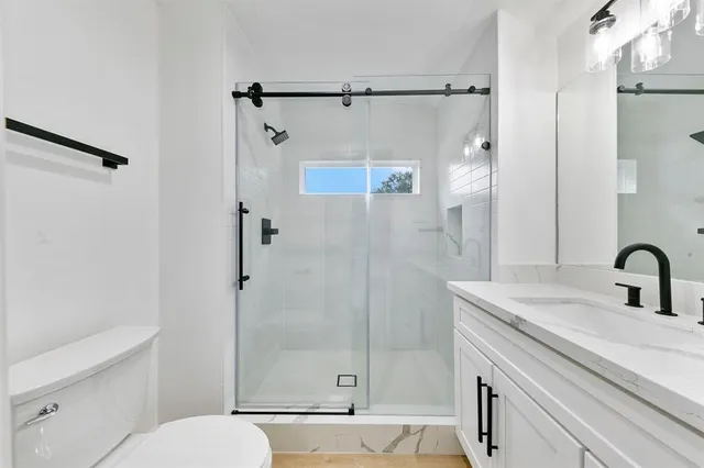 a bathroom with a sink vanity granite and a mirror