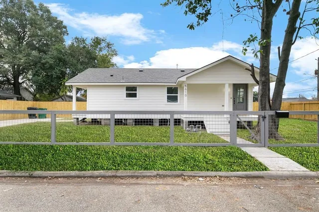 a view of a house with a backyard and a garden