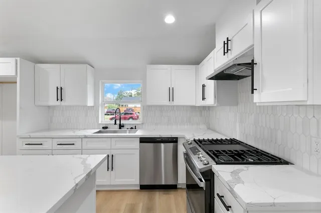 a hallway with a chandelier and wooden floor