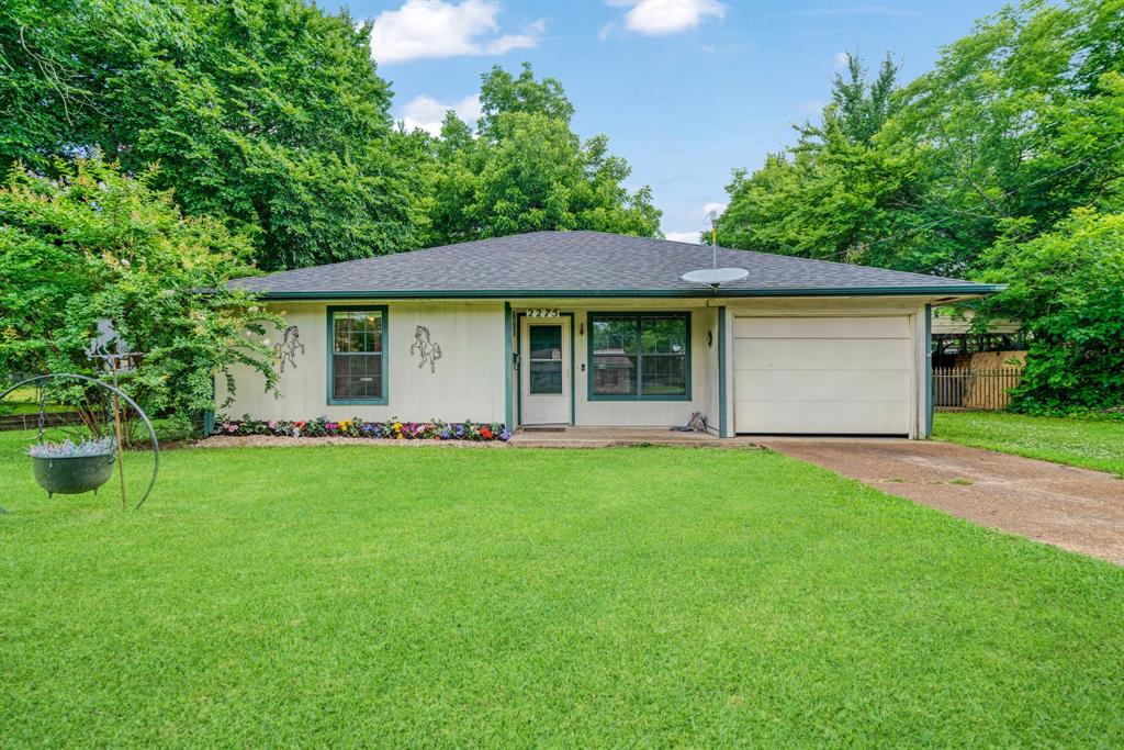 a view of a house with a backyard