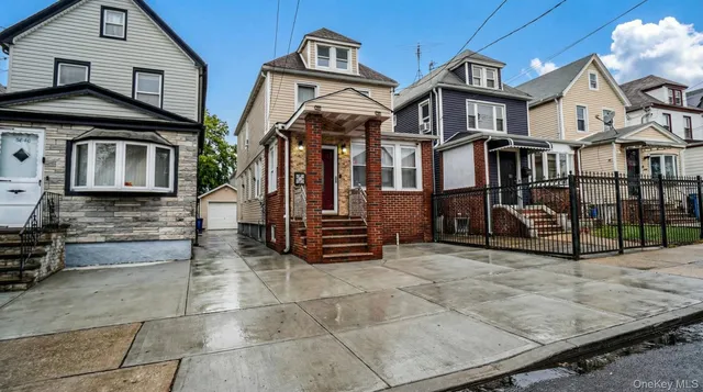 a view of a white house with large windows