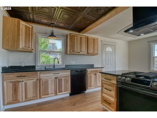a kitchen with stainless steel appliances granite countertop a stove and a sink