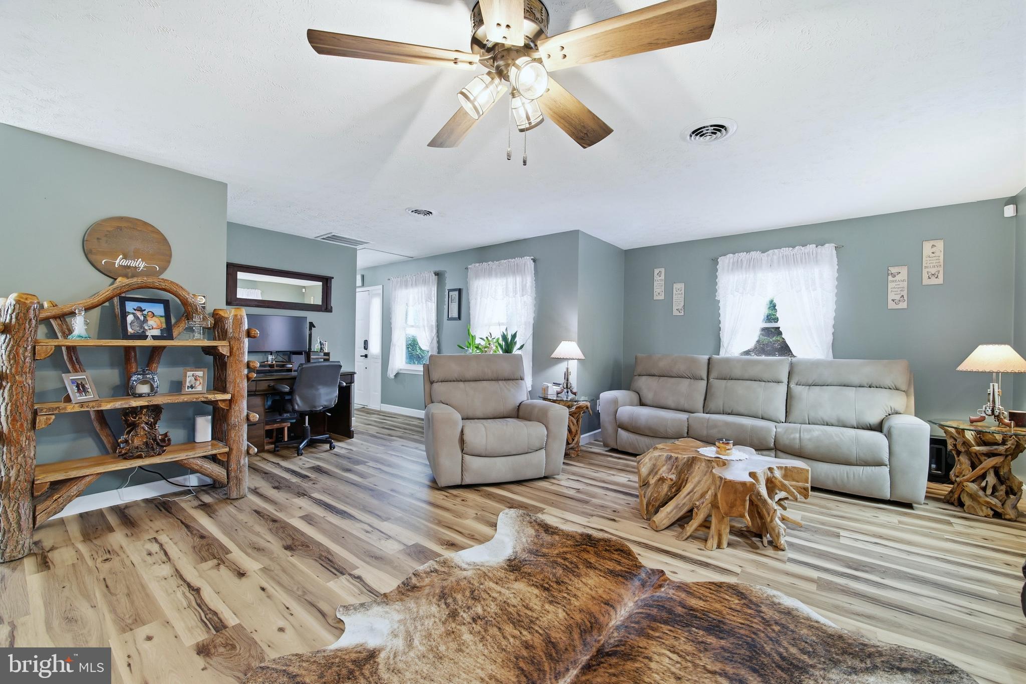 5911 Smith Creek Road New Market, VA 22844 - Photo 12 of 78 a living room with furniture a rug and a chandelier