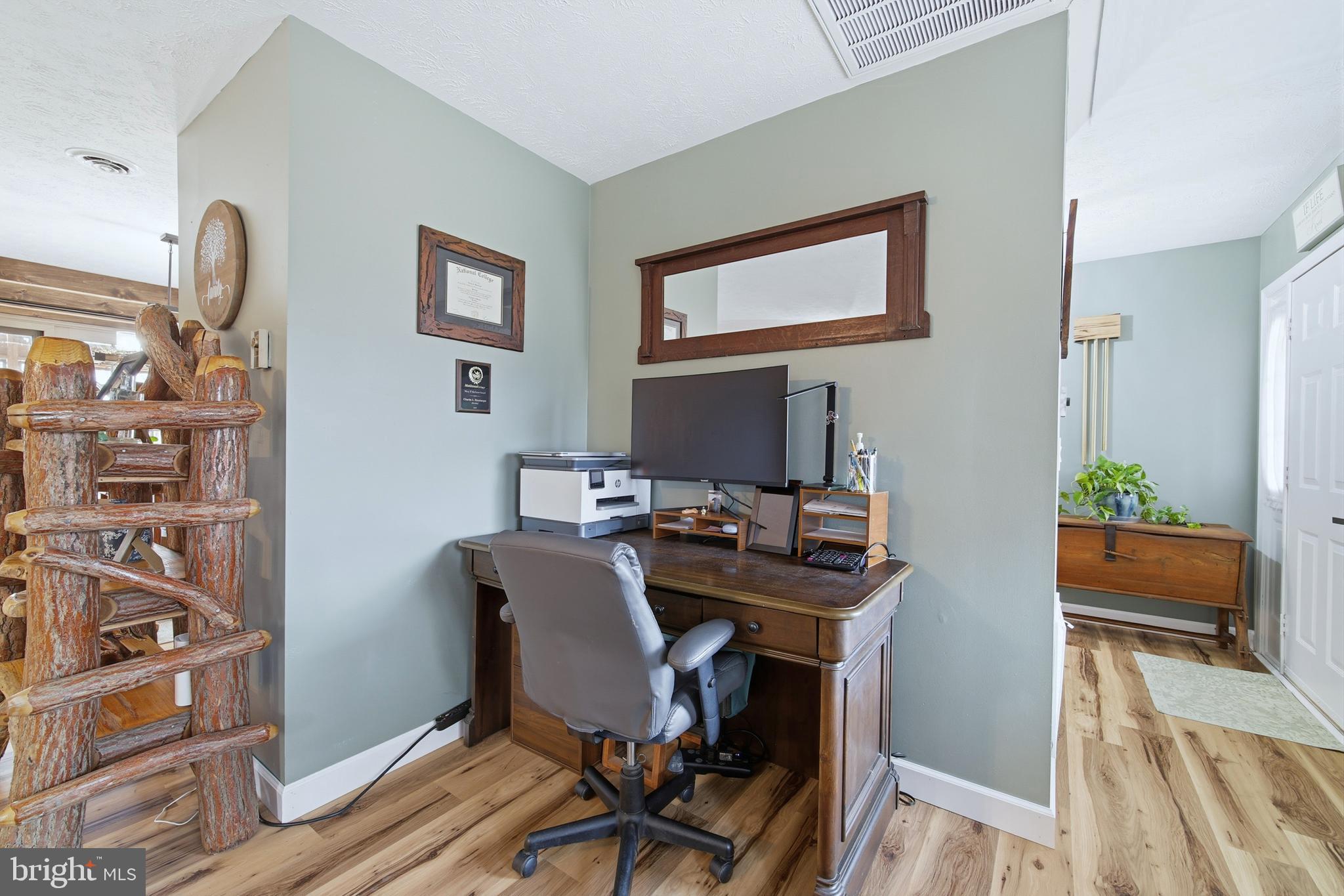 5911 Smith Creek Road New Market, VA 22844 - Photo 16 of 78 a view of a workspace with furniture and a potted plant