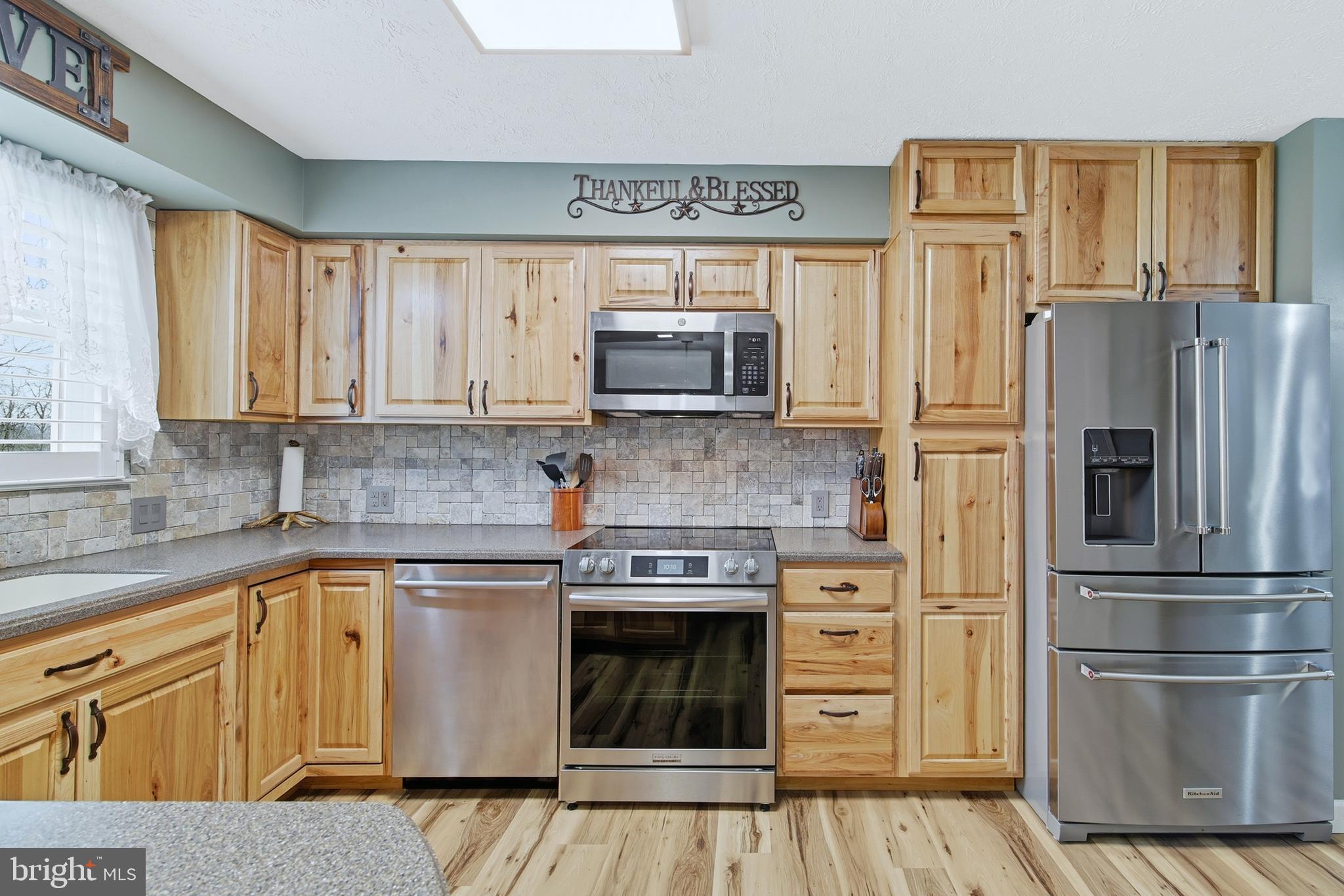 5911 Smith Creek Road New Market, VA 22844 - Photo 24 of 78 a kitchen with granite countertop a refrigerator stove and microwave