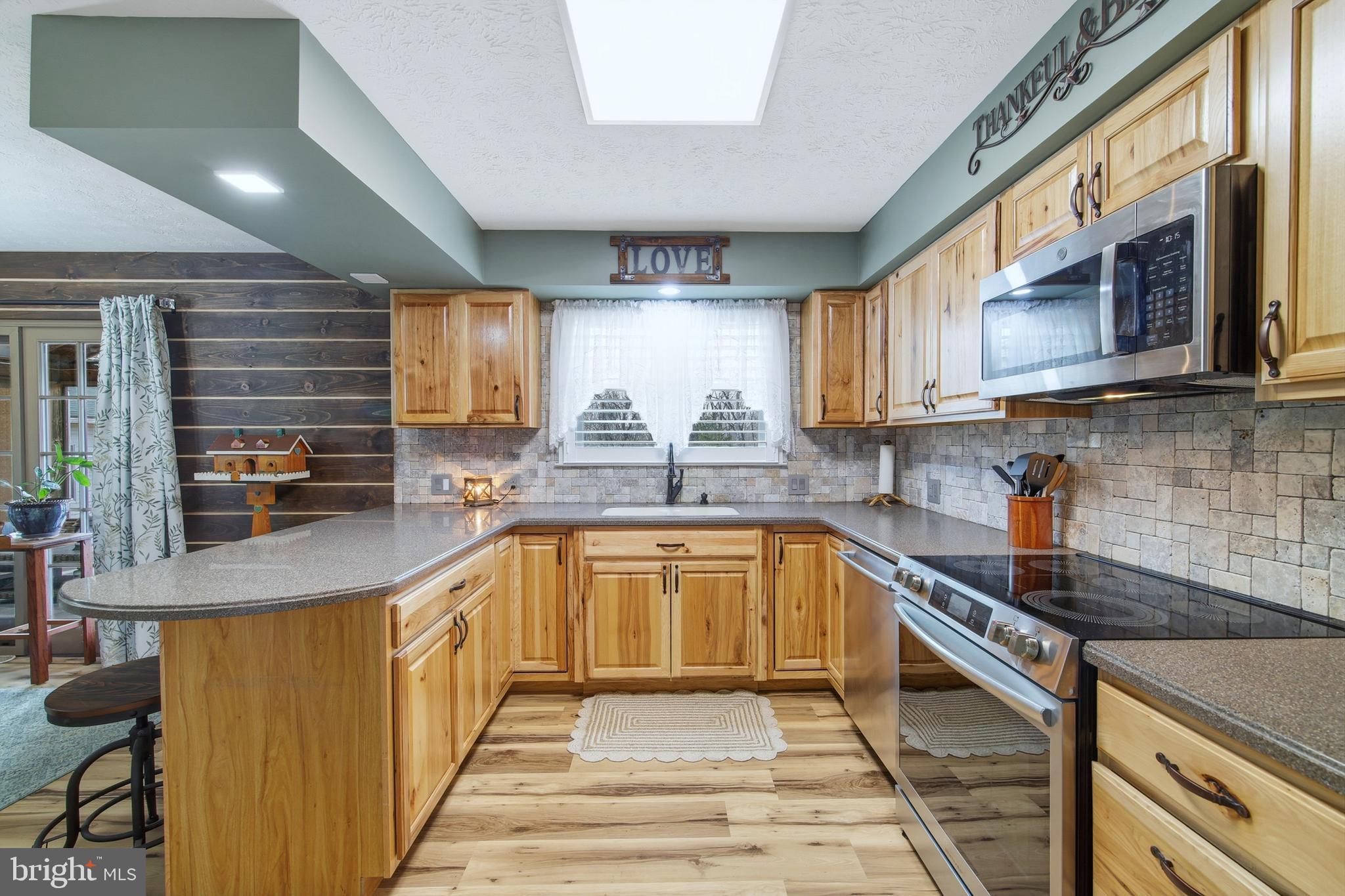 5911 Smith Creek Road New Market, VA 22844 - Photo 26 of 78 a kitchen with stainless steel appliances granite countertop a sink stove and cabinets