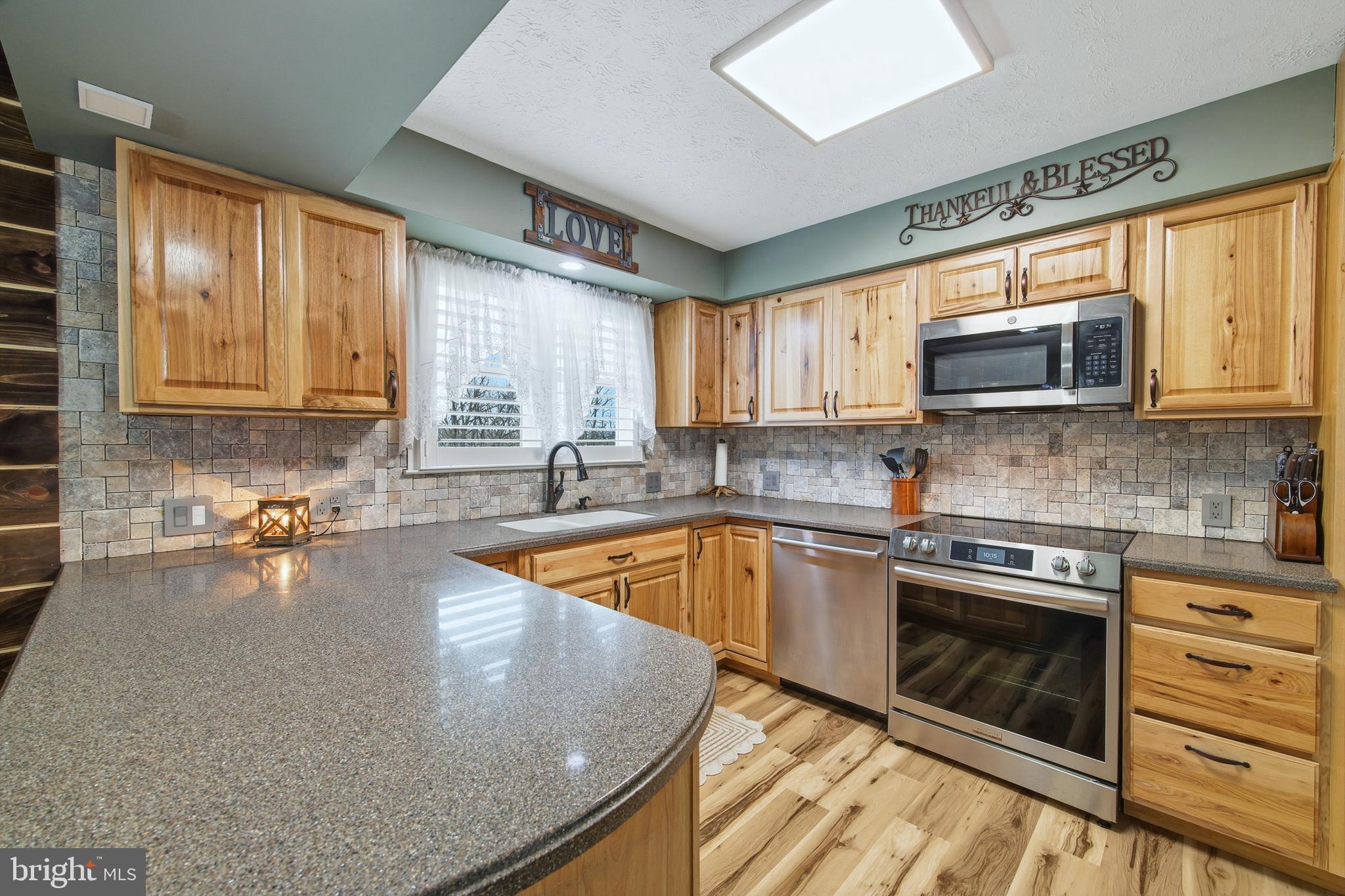 5911 Smith Creek Road New Market, VA 22844 - Photo 27 of 78 a kitchen with stainless steel appliances granite countertop a stove microwave and sink