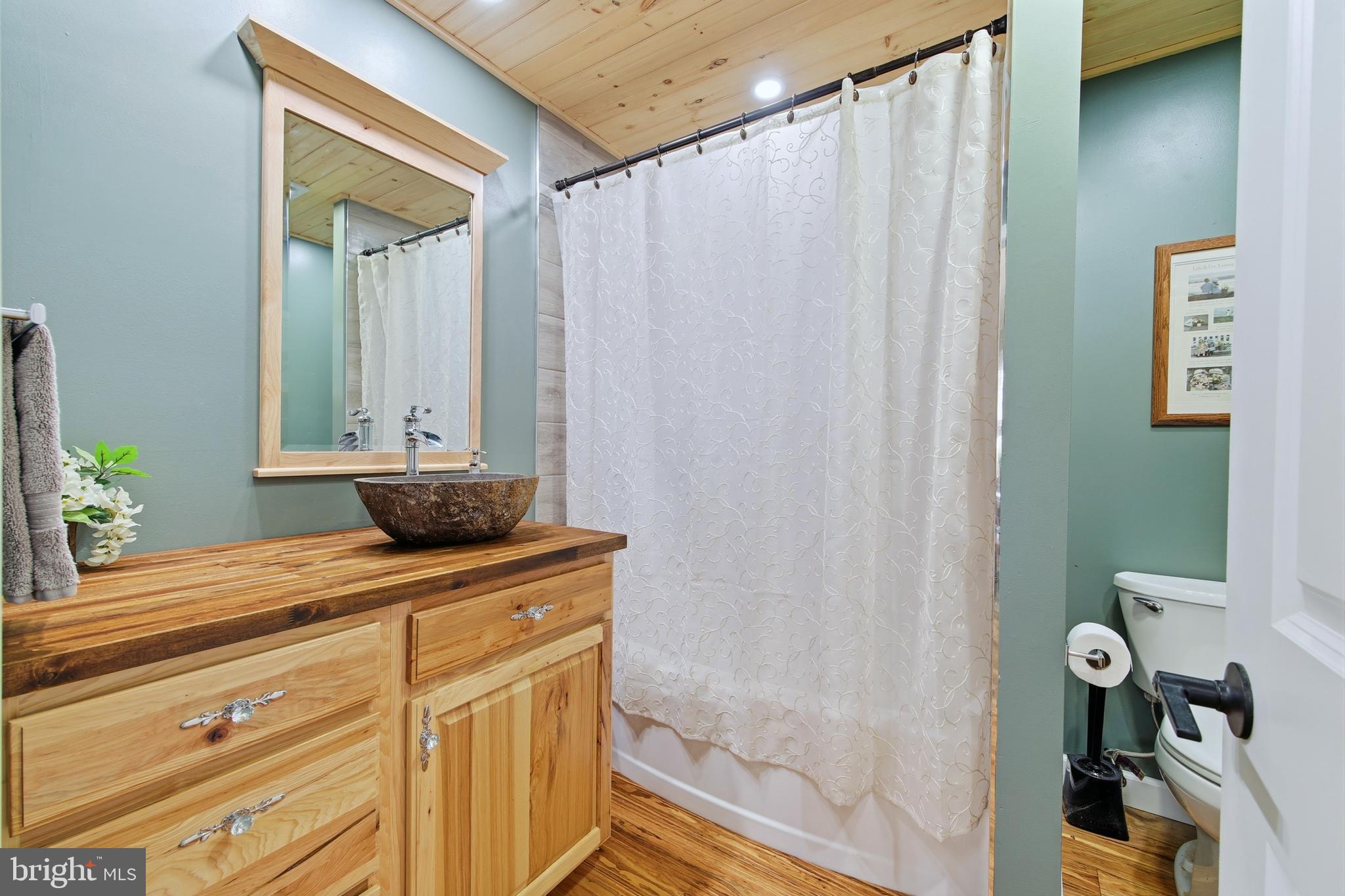 5911 Smith Creek Road New Market, VA 22844 - Photo 33 of 78 a bathroom with a granite countertop sink and a mirror