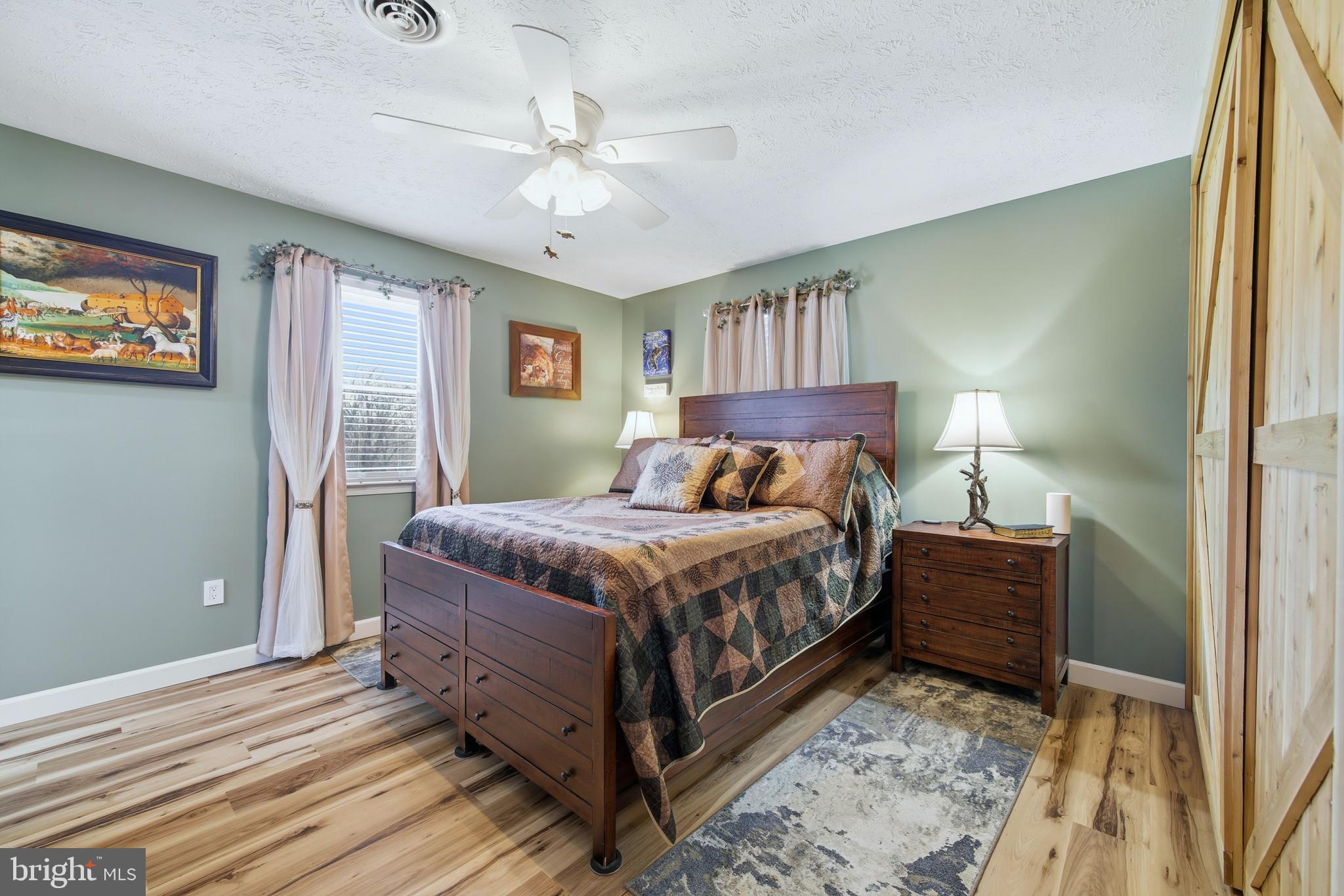 5911 Smith Creek Road New Market, VA 22844 - Photo 36 of 78 a bedroom with a bed chandelier and a window