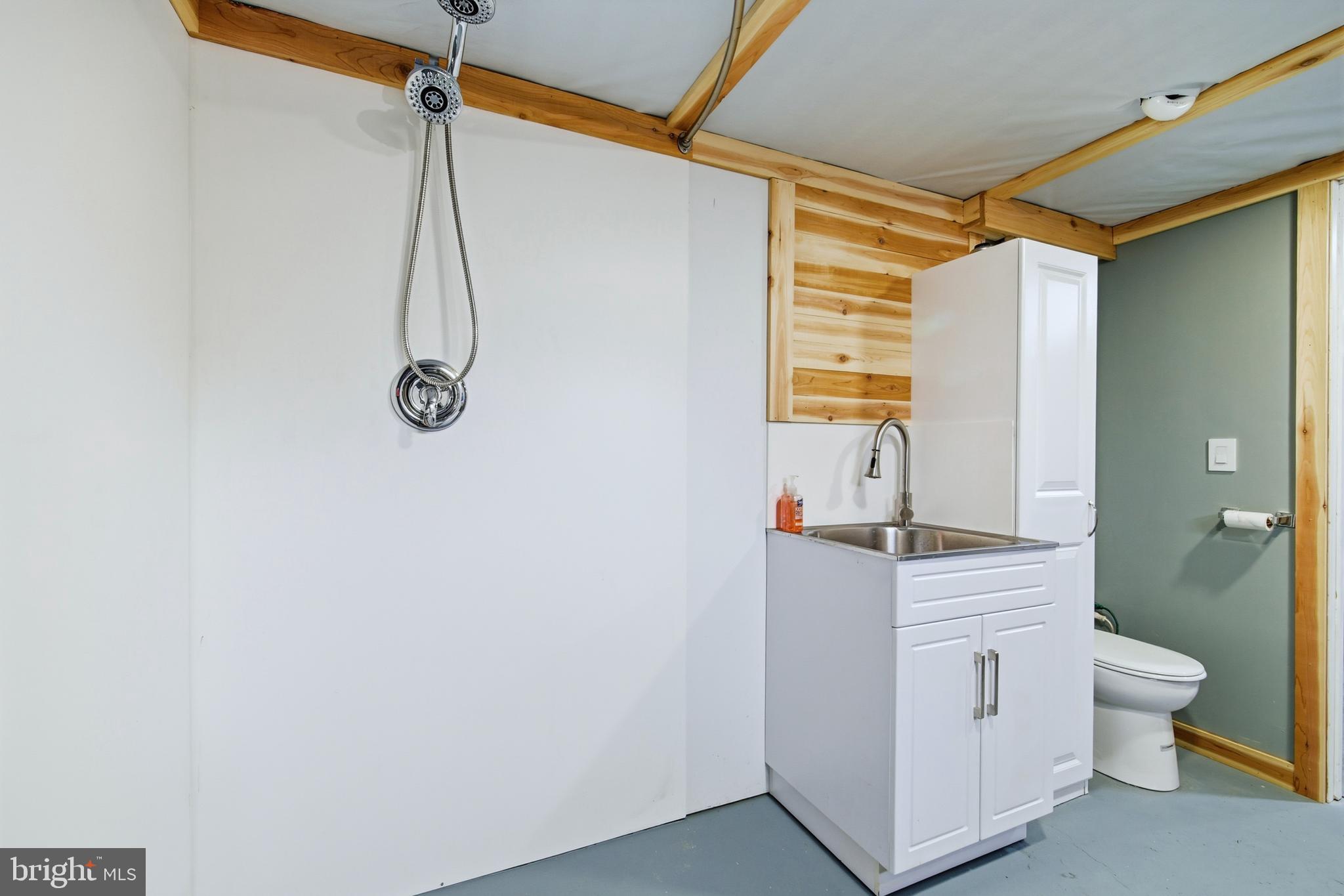 5911 Smith Creek Road New Market, VA 22844 - Photo 52 of 78 a bathroom with a granite countertop sink a toilet and shower