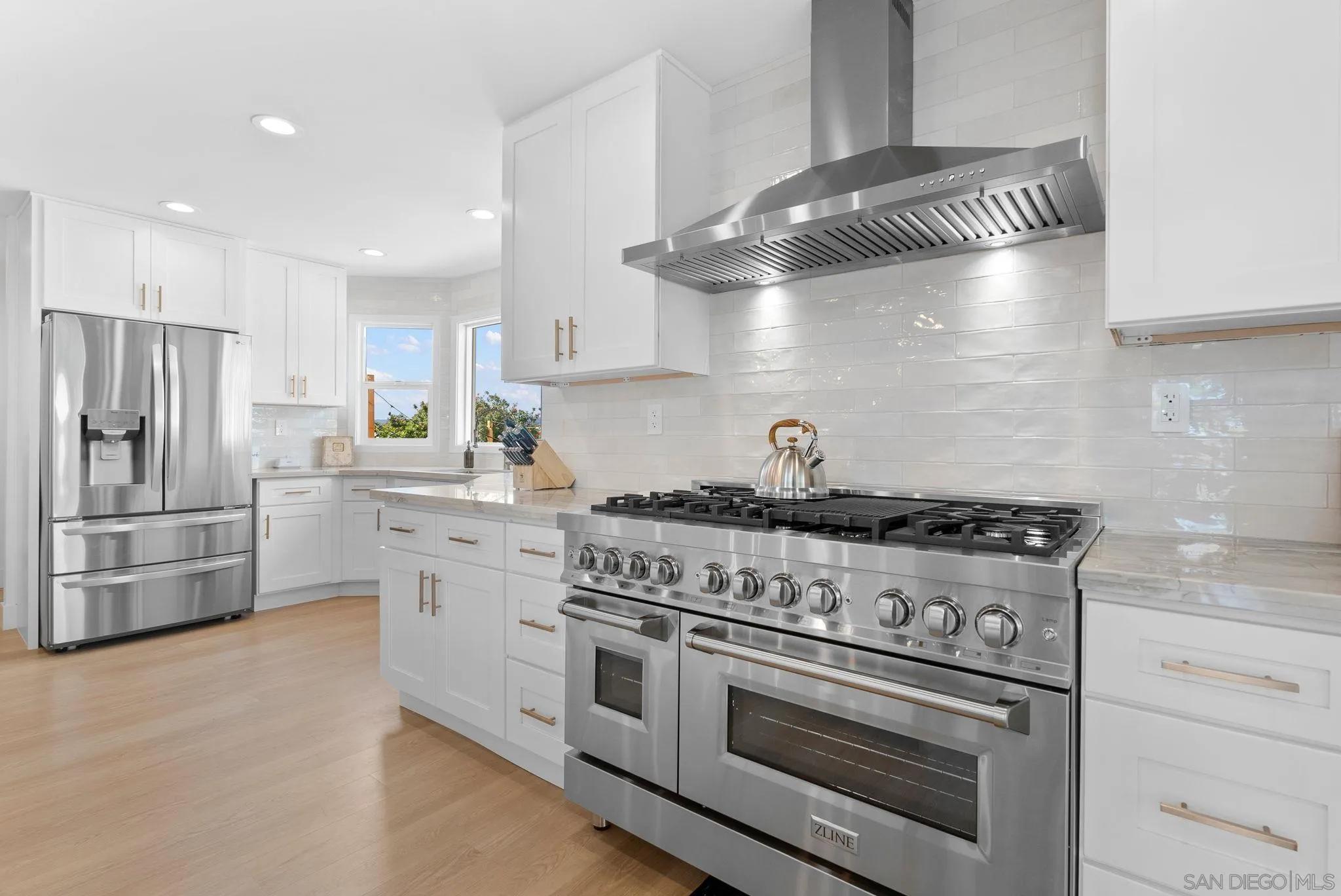 3168 Alta Verde Drive Fallbrook, CA 92028 - Photo 13 of 67 a kitchen with granite countertop stainless steel appliances and wooden floor