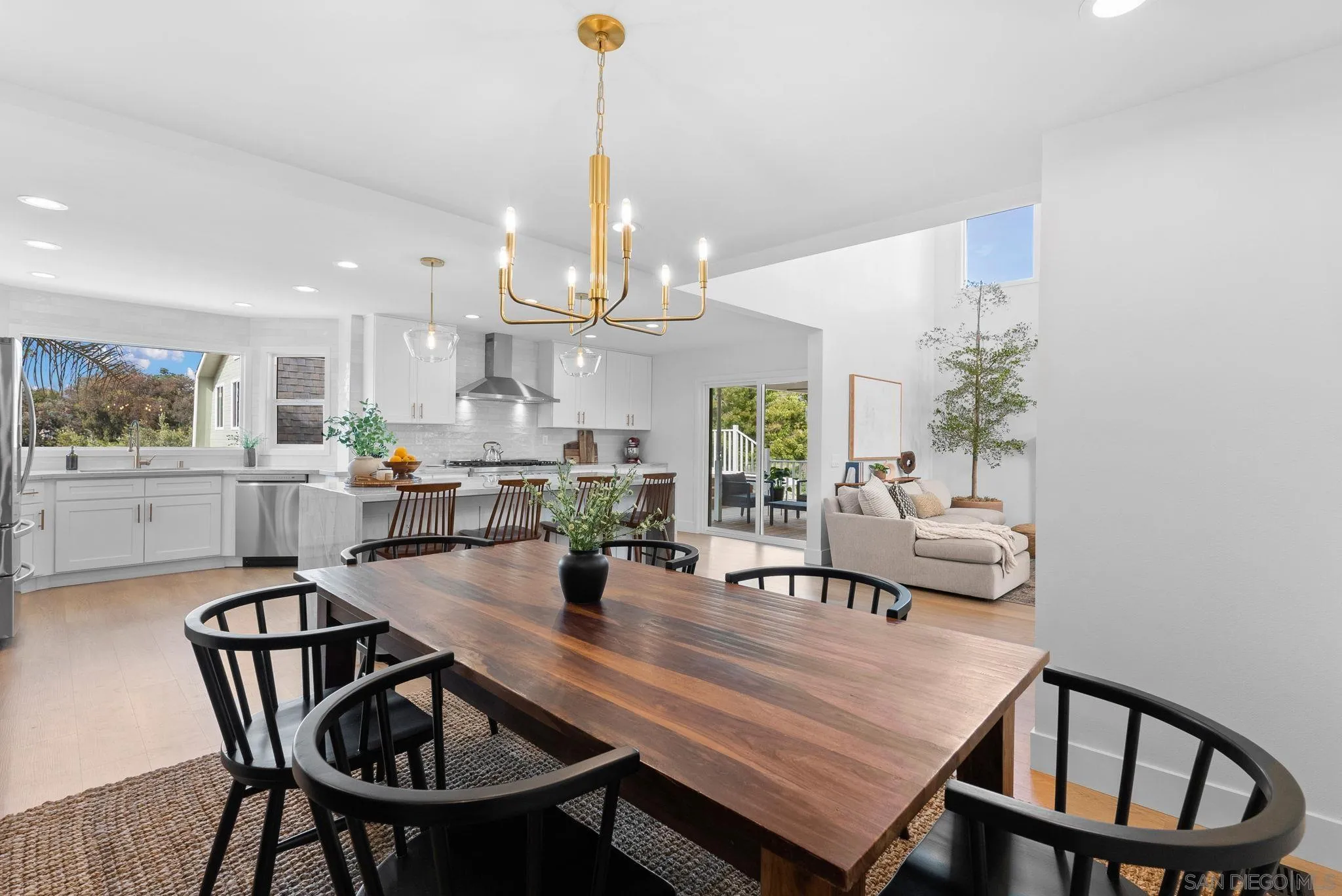 3168 Alta Verde Drive Fallbrook, CA 92028 - Photo 20 of 67 a view of a dining room and livingroom with furniture wooden floor a rug a painting and a chandelier