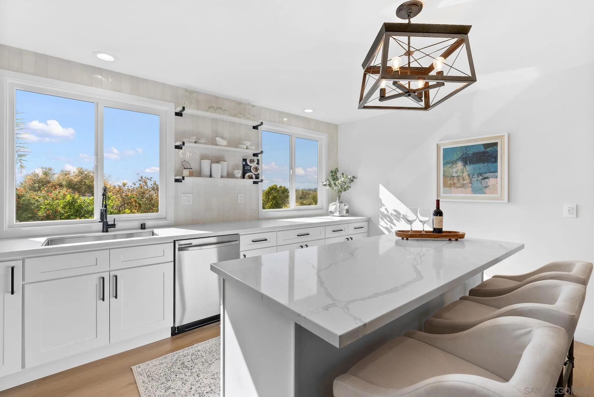 3168 Alta Verde Drive Fallbrook, CA 92028 - Photo 32 of 67 a kitchen with stainless steel appliances a sink a stove a chimney a dining table and chairs