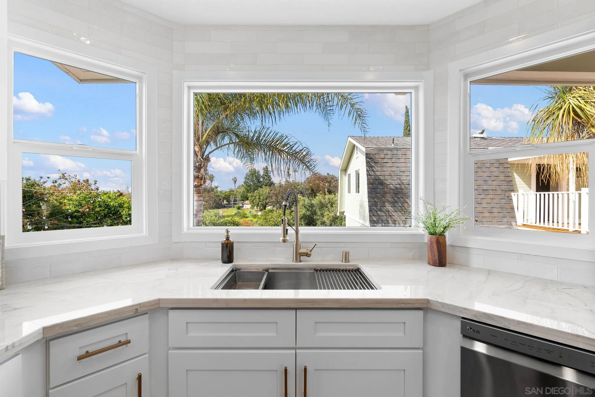 3168 Alta Verde Drive Fallbrook, CA 92028 - Photo 58 of 67 a kitchen with stainless steel appliances white cabinets and wooden floor