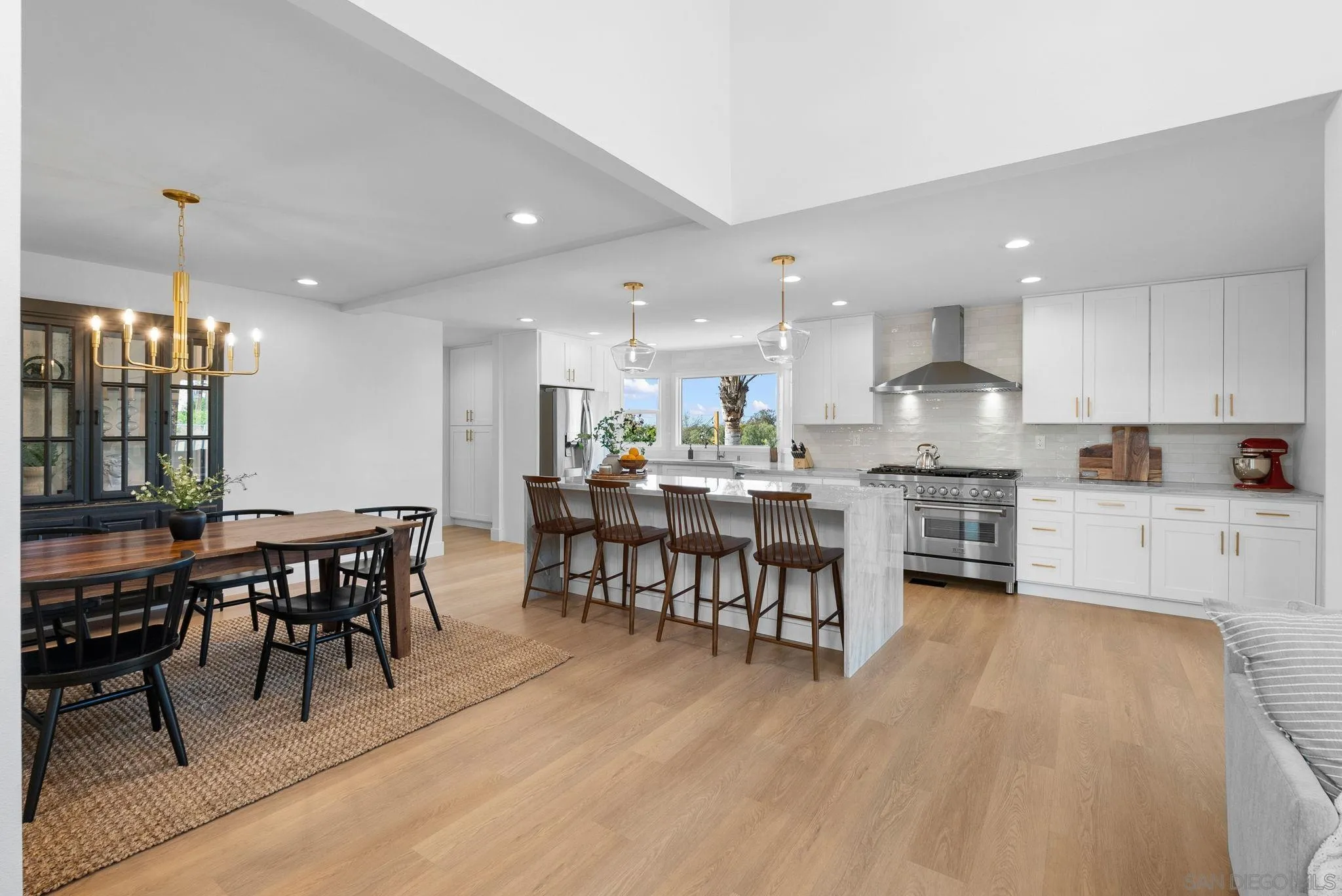 3168 Alta Verde Drive Fallbrook, CA 92028 - Photo 59 of 67 a kitchen with kitchen island a dining table chairs and white cabinets