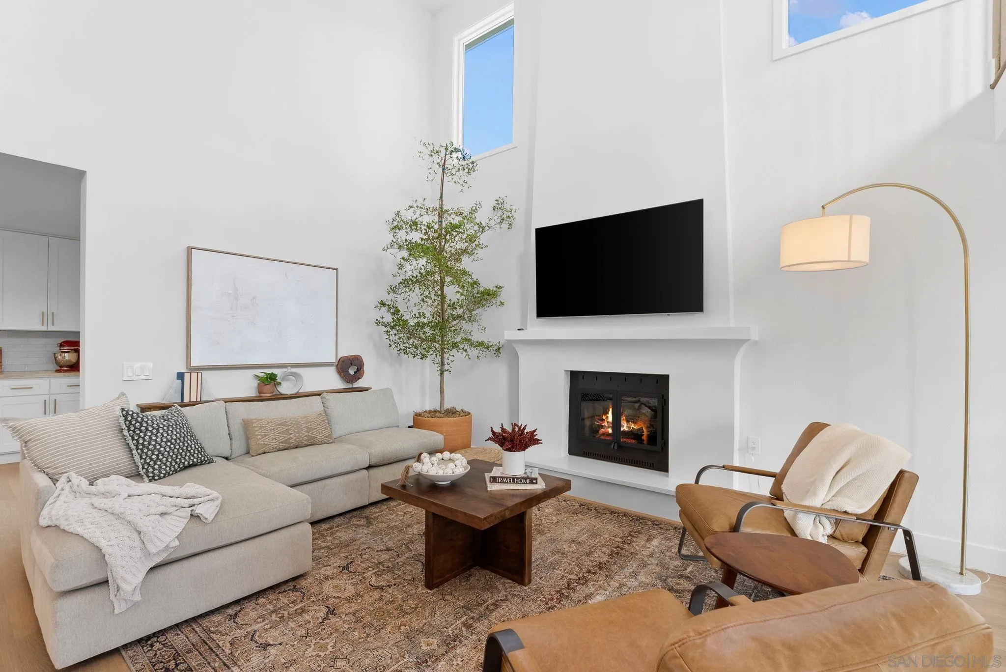 3168 Alta Verde Drive Fallbrook, CA 92028 - Photo 9 of 67 a living room with furniture a fireplace and a flat screen tv