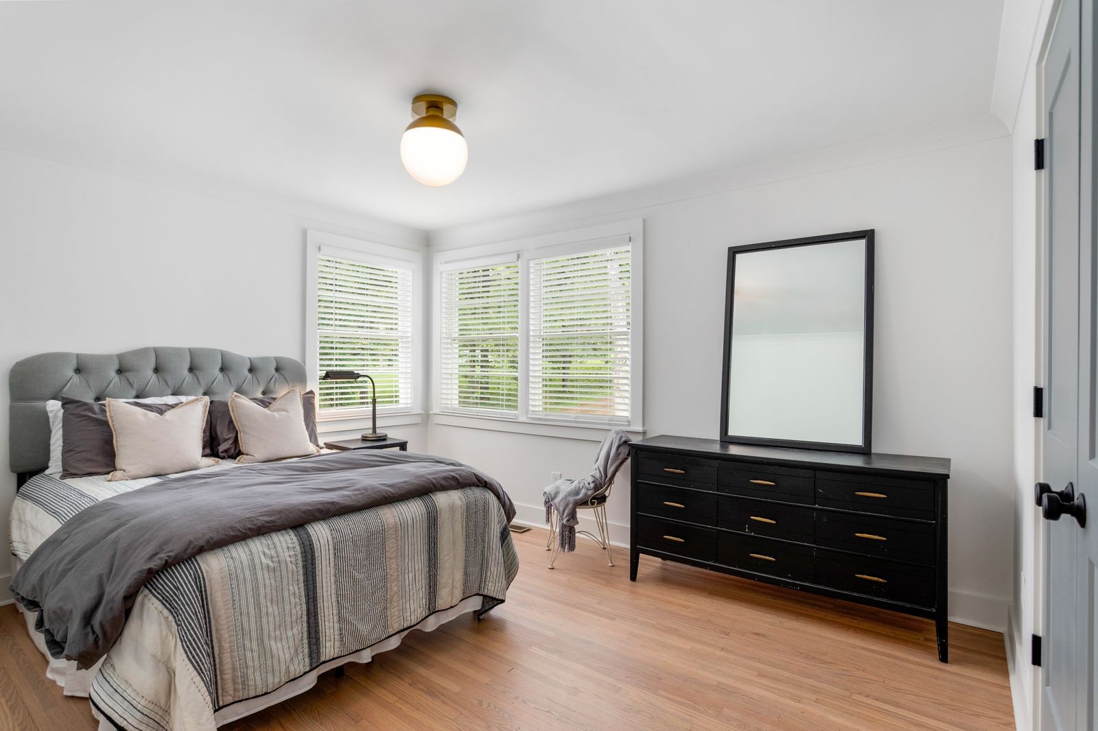 6437 Bresslyn Road Nashville, TN 37205 - Photo 27 of 47 a bedroom with a bed and a chandelier