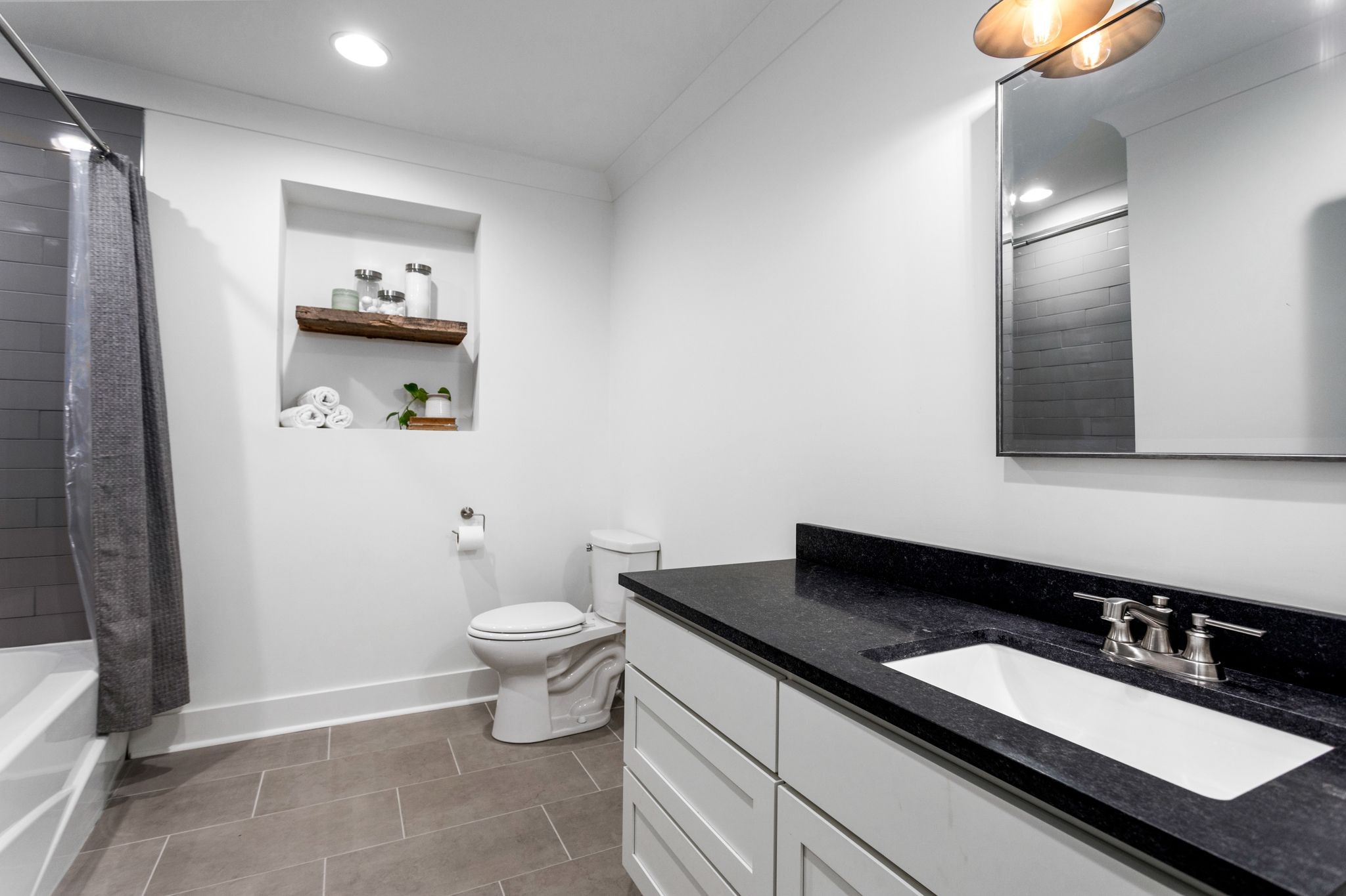 6437 Bresslyn Road Nashville, TN 37205 - Photo 30 of 47 a bathroom with a granite countertop sink and a mirror