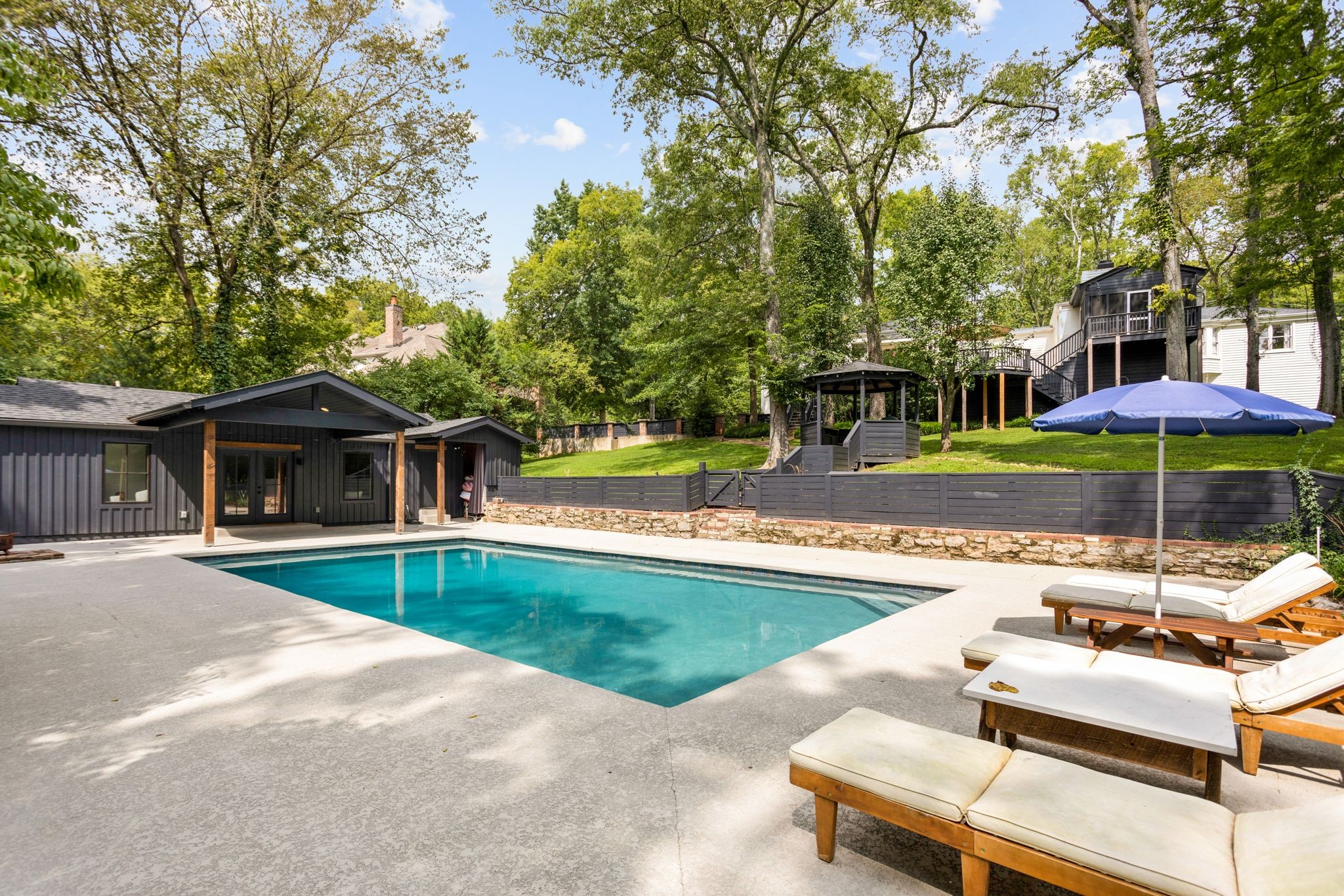 6437 Bresslyn Road Nashville, TN 37205 - Photo 41 of 47 a view of a house with swimming pool and sitting area