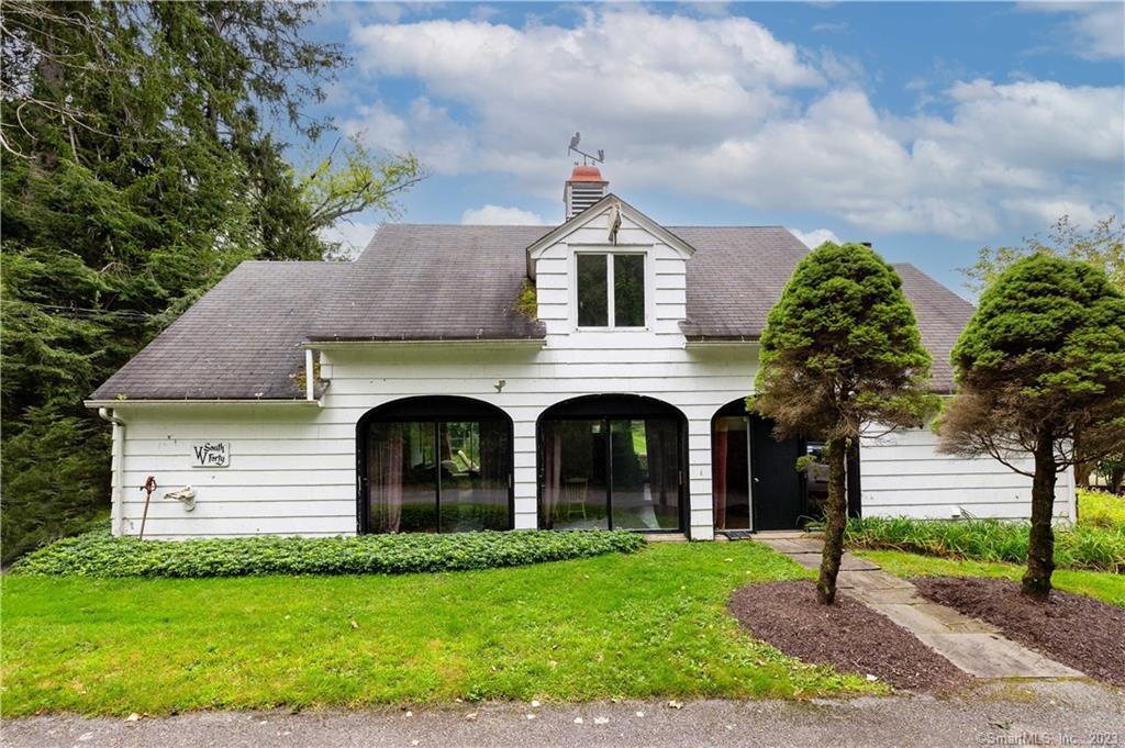 a front view of a house with a garden