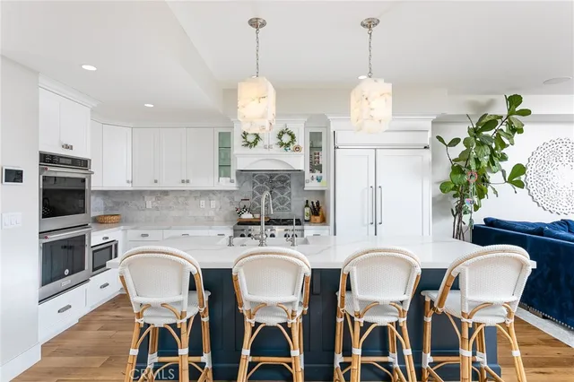 a kitchen with stainless steel appliances a stove a sink and a refrigerator